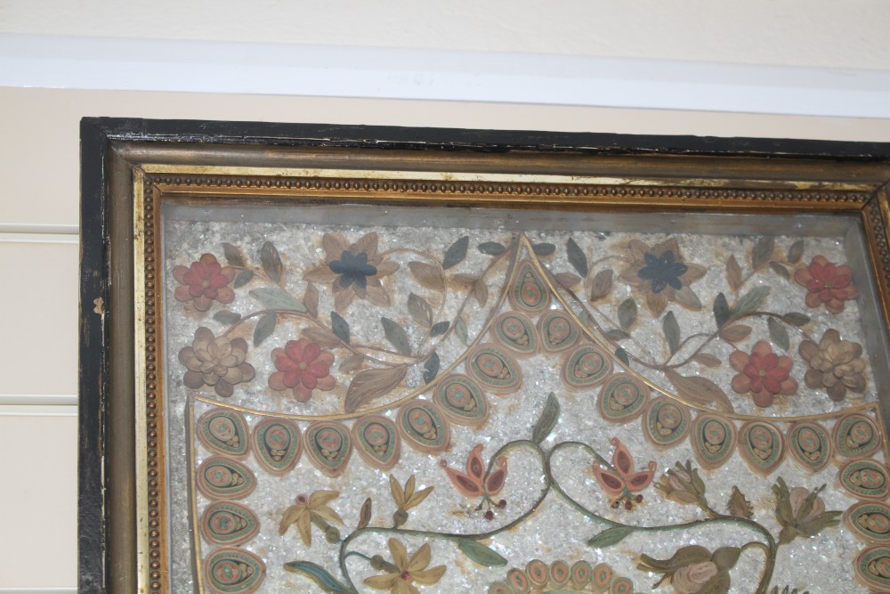 An early 19th century paper scroll work panel